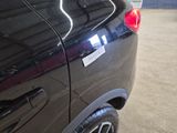 a black car with a sticker on the side of it