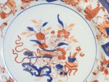 a blue and orange plate with a dragon on it
