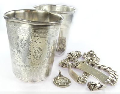 a silver cup with a cross on it next to other items