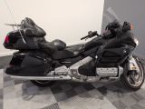 a picture of a black motorcycle parked on a checkered floor