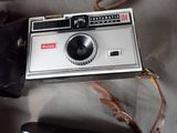 a camera and a cell phone sitting on a table
