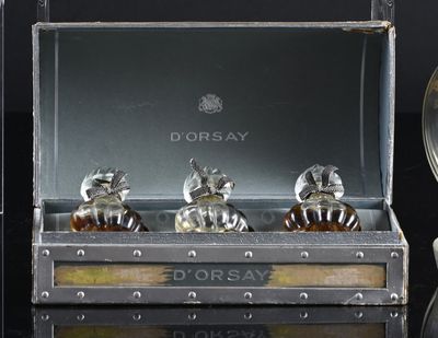three bottles of perfume sitting in a box on a table