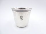 a silver cup with a handle on a white surface