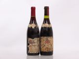 two bottles of wine sitting next to each other on top of a table