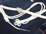 a close up of a uniform with a rope and a knife