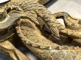 a close up of a wooden carving of a dragon