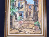 une peinture à l'huile représentant une scène de rue, posée sur un chevalet, avec une plante en pot
