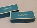 two blue boxes with white writing on them sitting on a table