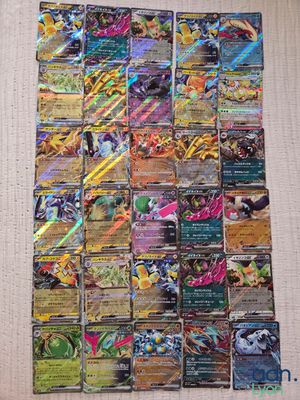 a pile of pokemon cards sitting on top of a table
