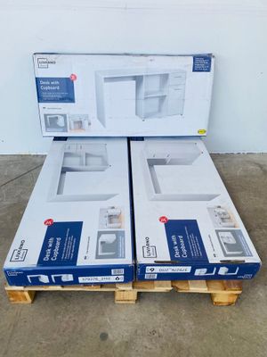 two boxes of microwaves sitting on a pallet in a warehouse