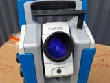 a close up of a blue and white camera on top of a cardboard box