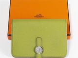 an orange and green wallet with a coin in the middle of it