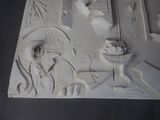 a relief of a woman with a basket of fruit on a table