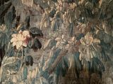a painting on the wall of a room that has a bunch of flowers on it