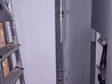 a ladder that is next to a refrigerator in a room