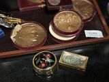 a tray with some gold coins and other items on a table