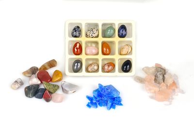 a tray of rocks and stones on a white surface