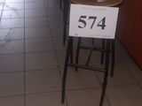 tables and chairs in a restaurant with a price sign in front of them