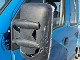 a close up of a blue van with a broken mirror