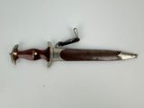 a picture of a knife that is on a white surface