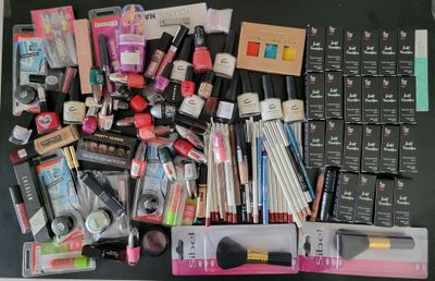 a lot of makeup and makeup products on the table