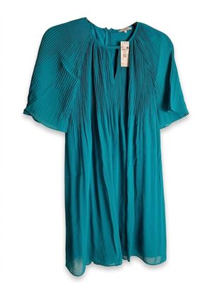 a women ' s teal green blouse with plea detailing