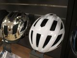three helmets on display in a glass case