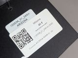 a black luggage tag with a qr code attached to it