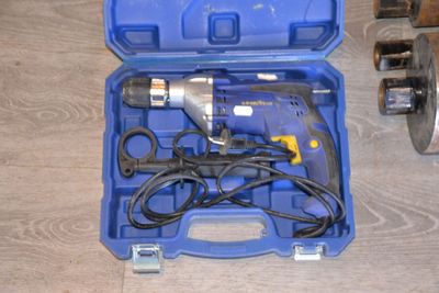 a blue tool case with tools in it on a wooden floor