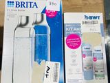 a bottle of water sitting on top of a table next to a package of toothpaste
