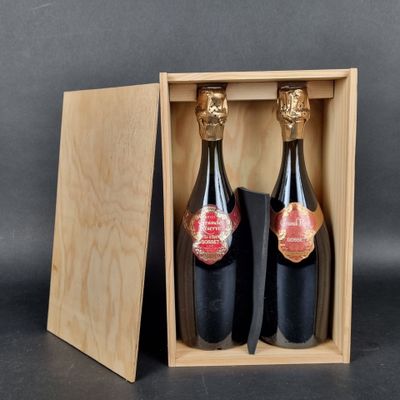 two bottles of wine in a wooden box on a table