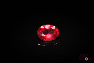 a red ruby gems on a black surface