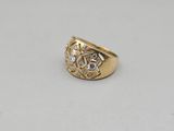 a close up of a gold and diamond ring on a white surface