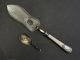 a silver spoon and a silver spoon with a clock on it