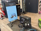 a television and a monitor in a room with a wooden floor