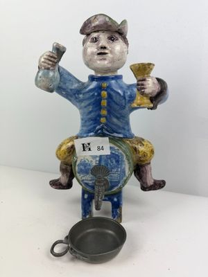 a figurine of a man riding a horse with a frying pan