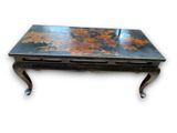 a black table with a floral design on it