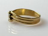a close up of a gold ring on a white surface