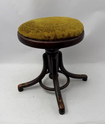 une image représentant un petit tabouret sur lequel est posé un coussin jaune