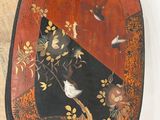 a black and red tray with birds and flowers on it