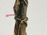 a bronze statue of a bird on top of a pole