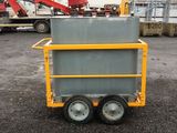 a yellow cart with a gray container on the back
