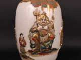 a white vase with a picture of a man on it