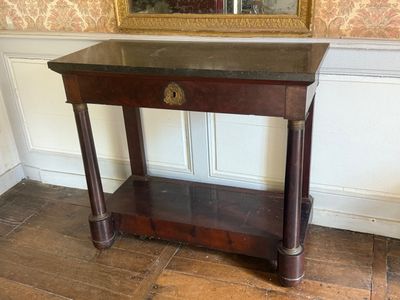 a wooden table with a marble top in front of a mirror