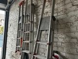 une échelle appuyée contre un mur de briques, à côté d'une borne d'incendie