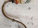 a small lamp that is on a table with a handle