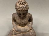 an image of a statue of a person sitting in a meditation position