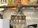 a glass chandelier hanging from the ceiling in a store