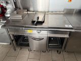 a large stainless steel kitchen with a sink and a stove