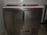 two stainless steel ovens in a kitchen with a tile floor